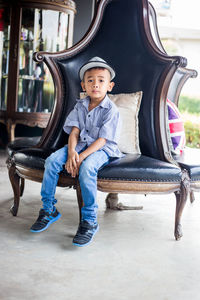 Portrait of boy sitting on seat