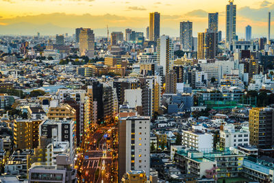 High angle view of buildings in city against sky during sunset