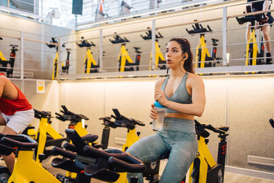 Young athlete on cardio bike in modern gym