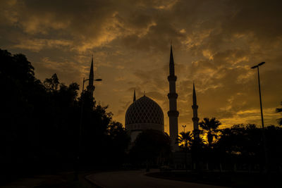 Silhouette of temple building against sky during sunset