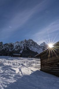 Snow covered landscape against sky