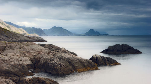 Scenic view of rocks in sea against sky