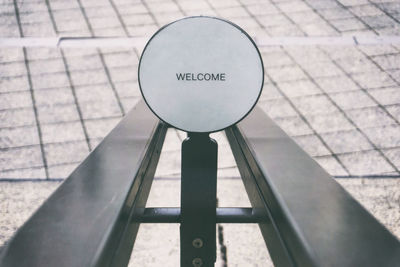 Close-up of welcome sign on metal