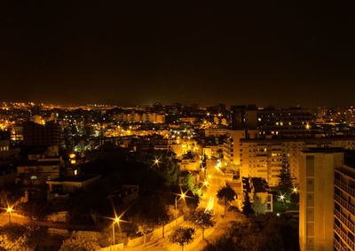 High angle view of illuminated cityscape against sky