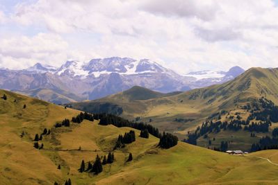 Scenic view of mountains against cloudy sky