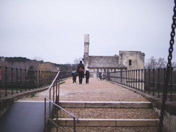 Man walking on footbridge