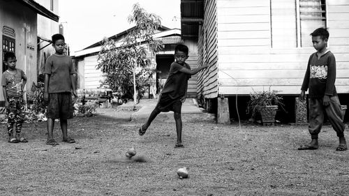 Boy with friends playing on field