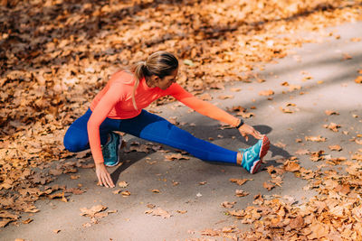 Woman stretching in the park after jogging.