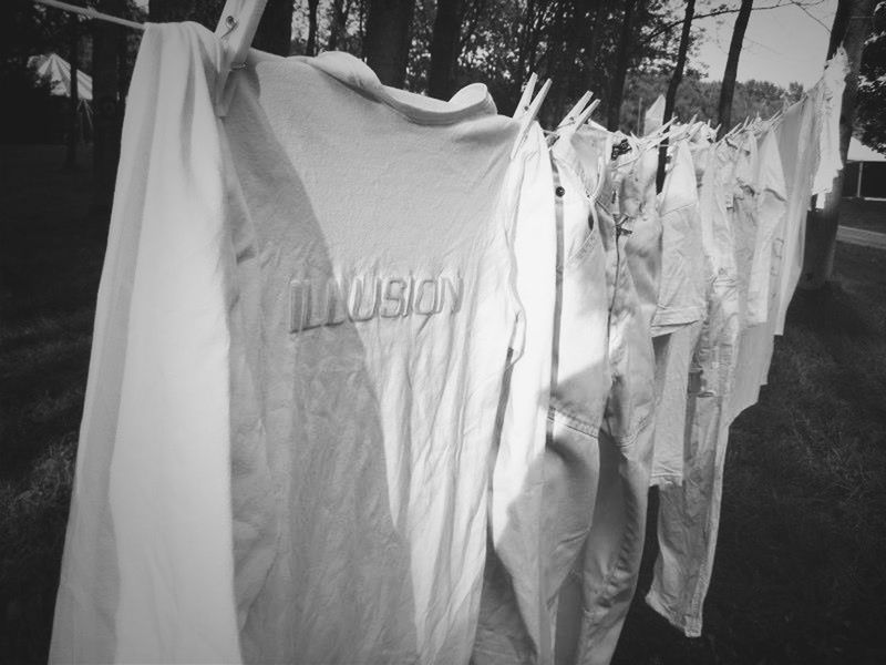 text, hanging, western script, clothing, white color, fabric, communication, paper, flag, textile, close-up, day, outdoors, sunlight, no people, non-western script, white, drying, clothesline, focus on foreground
