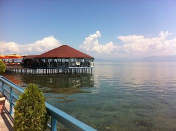 Built structure in sea against sky