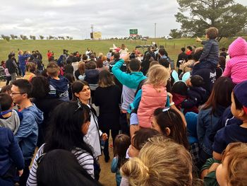 Rear view of people looking at crowd
