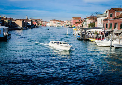 High angle view of boats on river in city