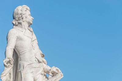 Low angle view of statue against blue sky