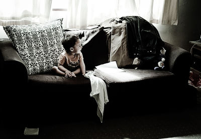 Boy sitting on sofa at home