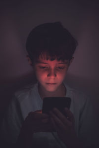 Close-up of boy using mobile phone