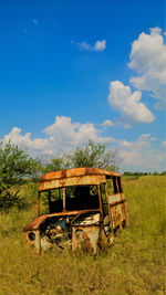 Abandoned barn on field against sky