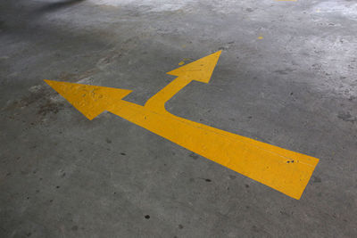 High angle view of arrow sign on road