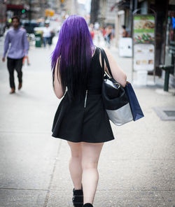 Rear view of woman walking on street