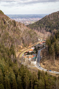 High angle view of road amidst trees against sky