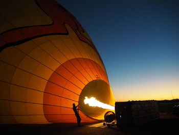 Silhouette hot air balloon against sky during sunset