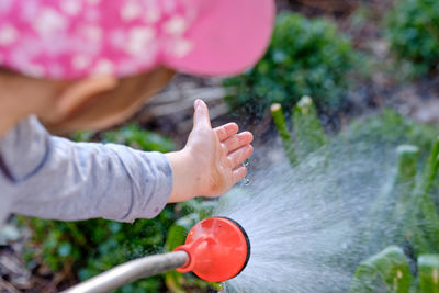 Midsection of woman playing in water