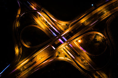 Aerial view of light trails on elevated road at night