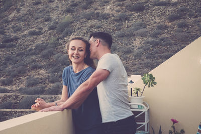 Young couple standing by railing