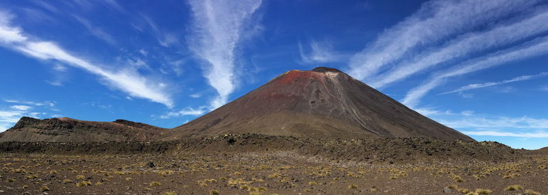 Scenic view of mountain against blue sky