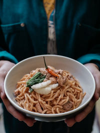 Midsection of person eating food in plate