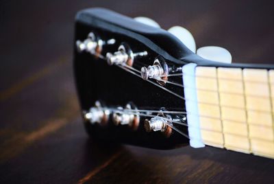 Close up of guitar on table