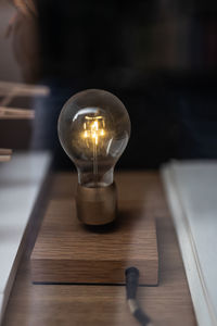 High angle view of illuminated light bulb on table