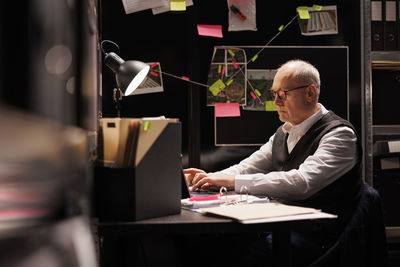 Businesswoman using laptop at desk in office