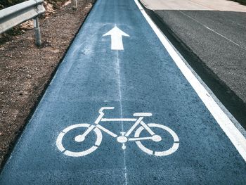 High angle view of arrow symbol on road