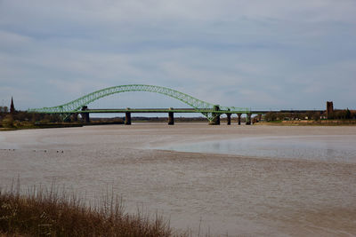 Bridge over sea against sky