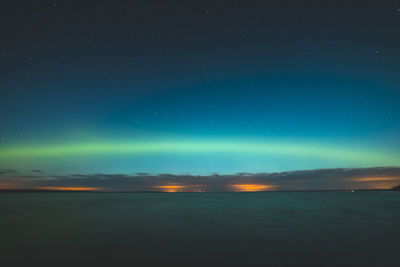 Scenic view of sea against northern lights