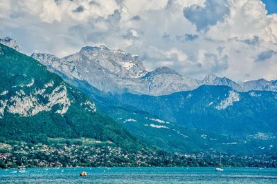 Scenic view of sea and mountains against sky