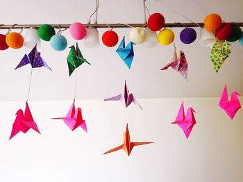 Low angle view of colorful lanterns hanging on tree