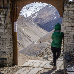 Rear view of woman standing in archway