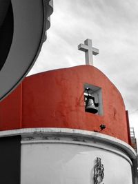 Low angle view of cross against sky