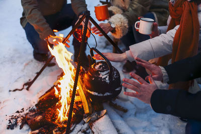 People enjoying bonfire during winter