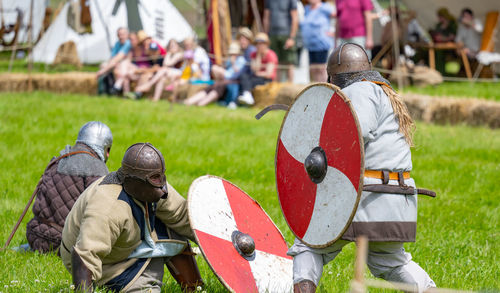 Show fight of medieval knights on a battlefield at the medieval market spectacle