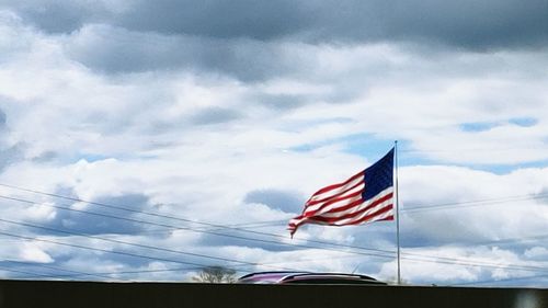 Low angle view of flag against sky