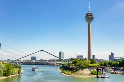 Bridge over river in city against clear sky