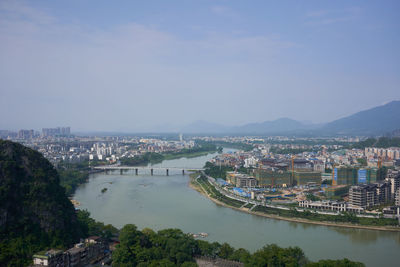 High angle view of river amidst buildings against sky