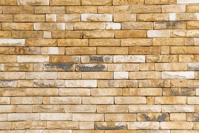 Background of modern yellow brick wall texture, abstract stone surface