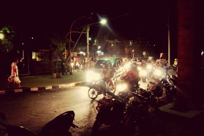 People on illuminated city at night