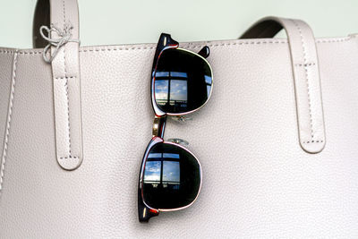 Close-up of sunglasses on mirror