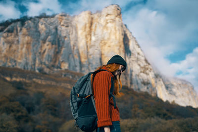 Rear view of person standing on rock