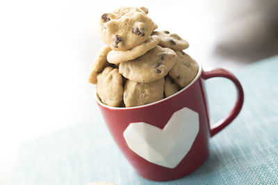 Close-up of cookies in mug on table