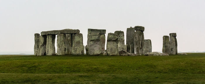 Old ruins in field against clear sky